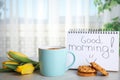Delicious coffee, cookies, flowers and GOOD MORNING wish on grey table indoors