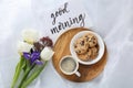 Delicious coffee, cookies, flowers and GOOD MORNING wish on white cloth