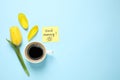 Delicious coffee, tulip and card with GOOD MORNING wish on light blue background, flat lay. Space for text