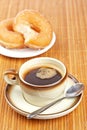 Delicious coffee and two donuts