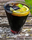 Delicious cold refreshing cola with ice and slice of lemon in a glass