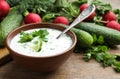 Delicious cold summer soup with kefir served on wooden table