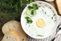 Delicious cold summer soup with kefir served on wooden table, flat lay