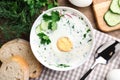 Delicious cold summer soup with kefir served on wooden table, flat lay