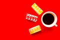 Delicious color bright cakes and coffee cup, top view. Bright red background Royalty Free Stock Photo