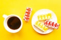 Delicious color bright cakes on a plate and coffee cup, top view. Royalty Free Stock Photo