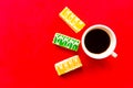 Delicious color cakes and coffee cup, top view. Bright red background Royalty Free Stock Photo