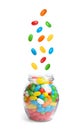 Delicious color jelly beans falling into jar on background Royalty Free Stock Photo