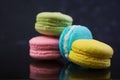 Delicious colorful macaron cakes on dark background Royalty Free Stock Photo