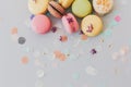 Delicious colorful macaroons on trendy pastel gray paper with li