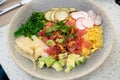 delicious colorful poke bowl with many ingredients at seafood restaurant during the day