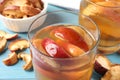 Delicious compot with dried apple slices on light blue table, closeup