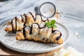 Delicious continental breakfast with fresh flaky french croissants and coffee, close up on the croissants. With white camellias Royalty Free Stock Photo