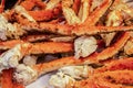 Delicious cooked king crab legs piled up on butchers paper - ready to eat - selective focus