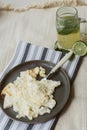 Delicious cooked omelet on a gray napkin and beige carpet. Homemade lemonade and scrambled eggs for breakfast. Dark dishes Royalty Free Stock Photo