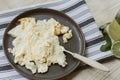 Delicious cooked omelet on a gray napkin and beige carpet. Homemade lemonade and scrambled eggs for breakfast. Dark dishes Royalty Free Stock Photo