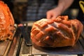 Delicious cooked and resting whole joint of roast gammon with turkey in the background Royalty Free Stock Photo