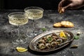 Delicious cooked sea escargo snails with herbs, butter, garlic on metal plate with forks. wine glass. gourmet food. Restaurant Royalty Free Stock Photo