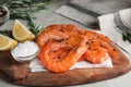 Delicious cooked shrimps, lemon and salt on board