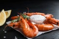 Delicious cooked shrimps and salt on table