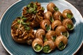 Delicious cooked snails served on table, closeup Royalty Free Stock Photo