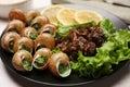 Delicious cooked snails served on white table, closeup Royalty Free Stock Photo