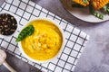 Delicious corn cream soup in a bowl on the table top view Royalty Free Stock Photo