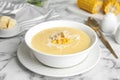 Delicious corn cream soup served on marble table