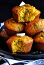Delicious corn muffins with spinach and butter on a black plate Royalty Free Stock Photo