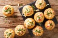 Delicious corn muffins stuffed with seafood herbs and cheese close-up on a slate board. horizontal top view