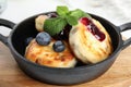 Cottage cheese pancakes with blueberries, mint and jam in pan Royalty Free Stock Photo