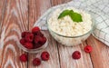 Delicious cottage cheese and ripe raspberries on the wooden table. Healthy breakfast. Close-up Royalty Free Stock Photo