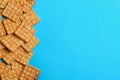 Delicious crackers on light blue background, flat lay. Space for text Royalty Free Stock Photo