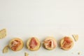 Delicious crackers with prosciutto on white wooden table, flat lay. Space for text Royalty Free Stock Photo