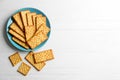 Delicious crackers on white wooden table, flat lay. Space for text Royalty Free Stock Photo