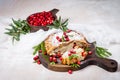 Delicious cranberry pie with fresh cranberries and herbs for Christmas on wooden plate