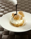 Delicious cream puff cake with chocolate syrup