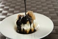 Delicious cream puff cake with chocolate syrup