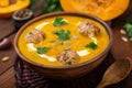 Delicious cream of pumpkin soup with meatballs made of turkey minced meat