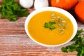 Delicious cream pumpkin soup on the wooden table. Preparing food from seasonal vegetables. Close-up. Copy space Royalty Free Stock Photo