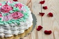 Delicious creamy cake basket of roses (half cake) on wooden table