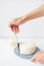 Delicious creamy cake that the girl spreads over the whipped cream with a spatula, the cake is ready for decoration Royalty Free Stock Photo