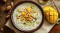 Delicious creamy doi chira rice pudding with mango, nuts and spices on wooden table Royalty Free Stock Photo
