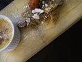 Delicious creme brulee served in white ramekin with with fresh strawberry and mandel biscuits