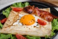 Delicious crepe with egg on plate, closeup. Breton galette