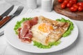 Delicious crepe with egg served on white tiled table. Breton galette