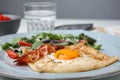 Delicious crepe with egg on table, closeup. Breton galette