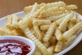 Delicious crinkle cut style french fries with ketchup Royalty Free Stock Photo