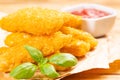 Delicious crispy chicken fillet in bread crumbs with ketchup , close-up on a wooden background. fast food Royalty Free Stock Photo