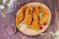 Delicious crispy fried breaded chicken breast strips with ketchup. Isolated on wooden background Royalty Free Stock Photo